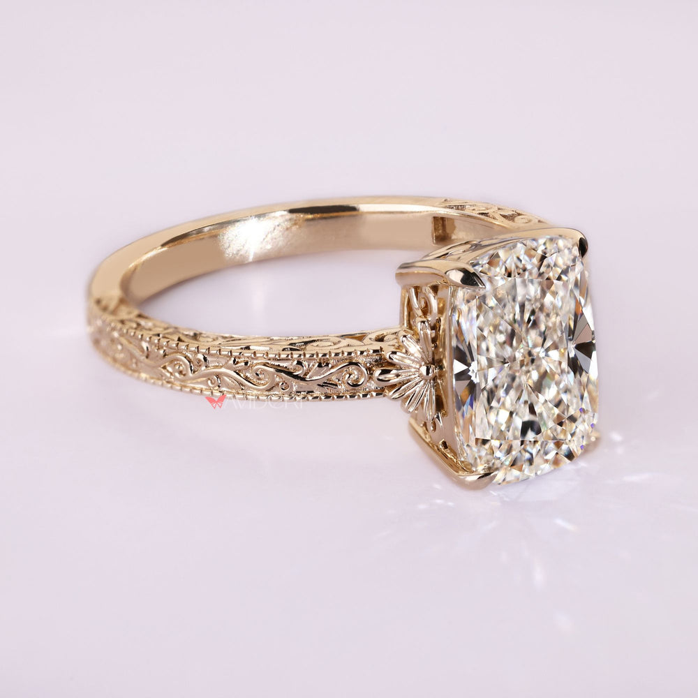 Cushion diamond ring with filigree and scrollwork.
