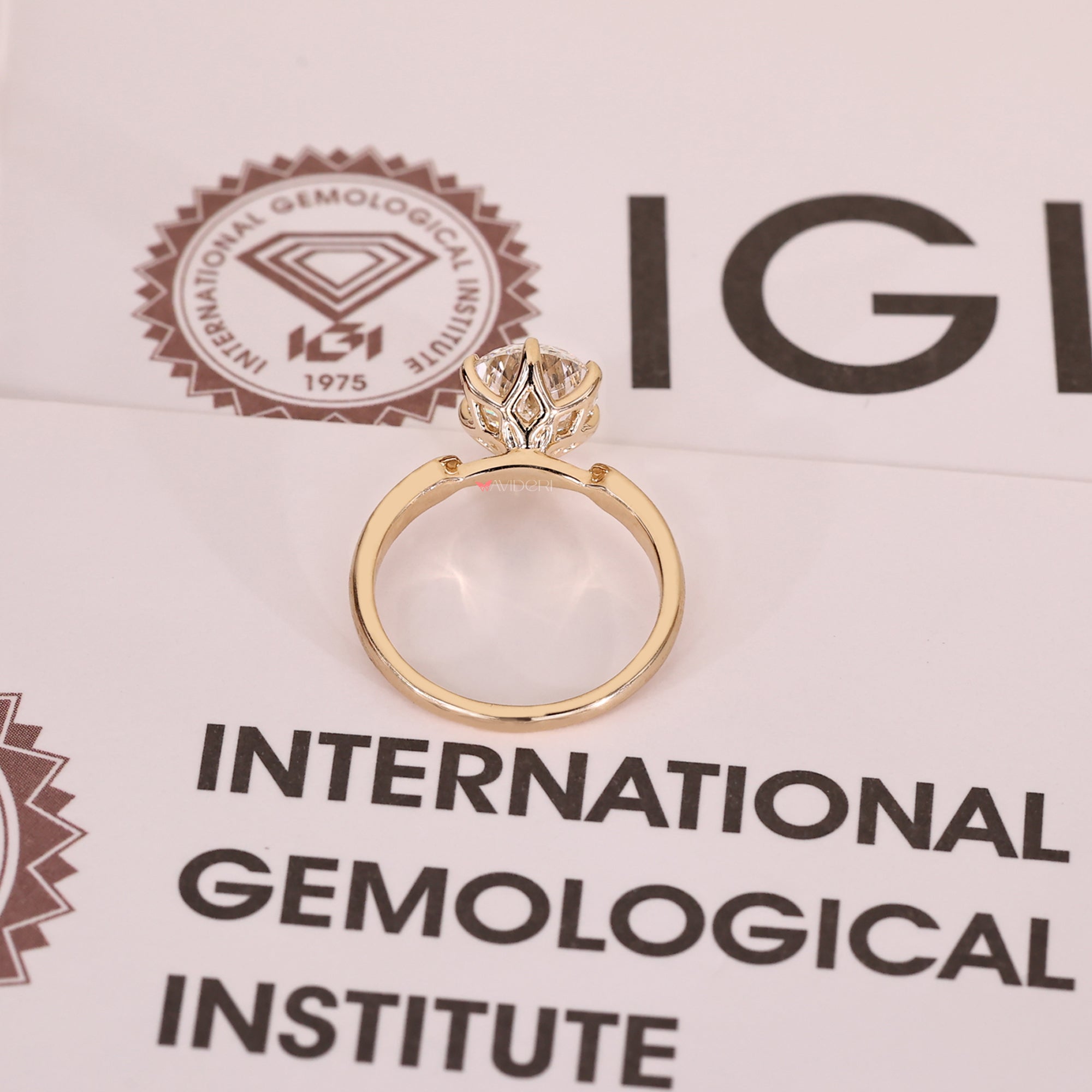 Yellow gold engagement ring with 6 claw prong setting.