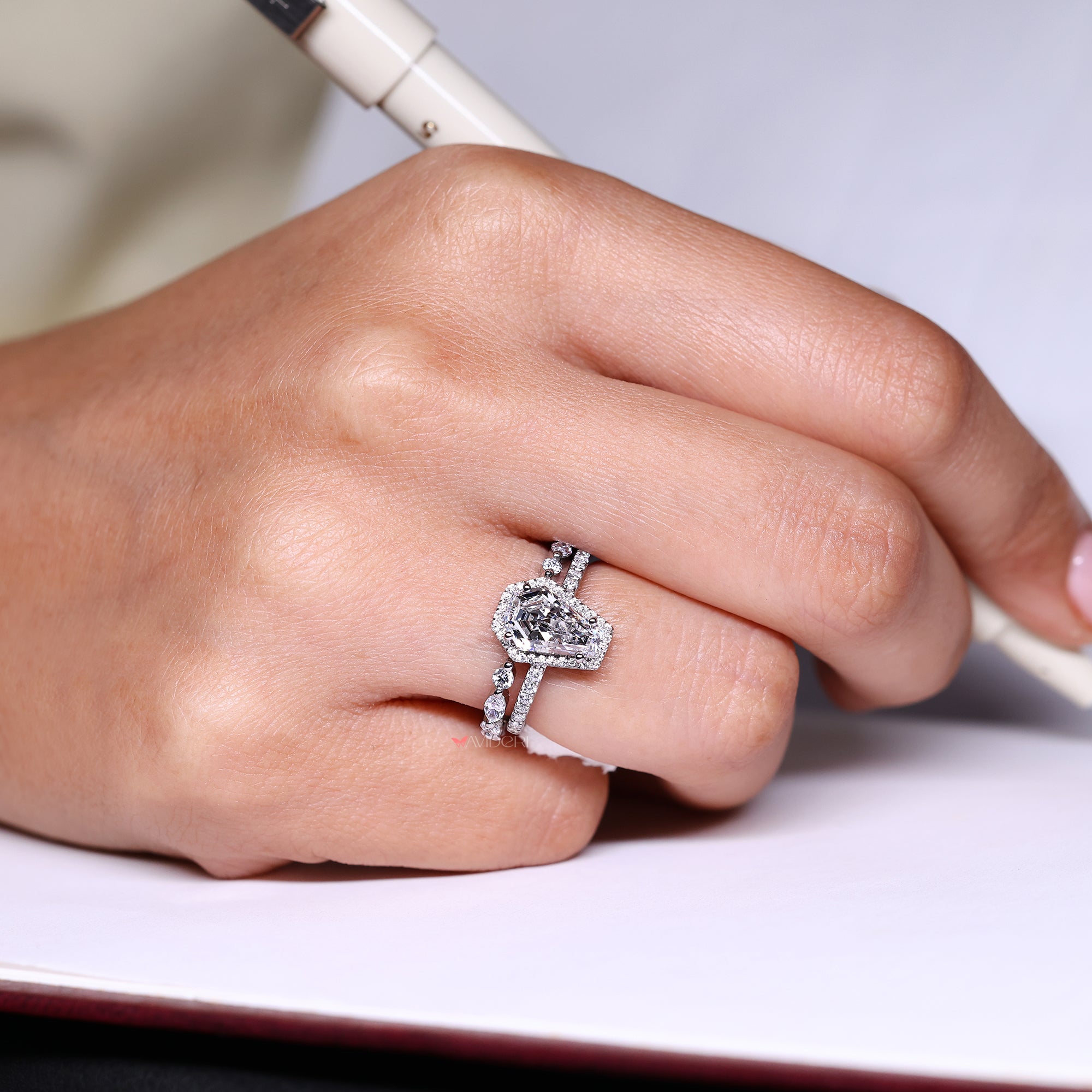 Coffin cut engagement ring with halo diamond ring.