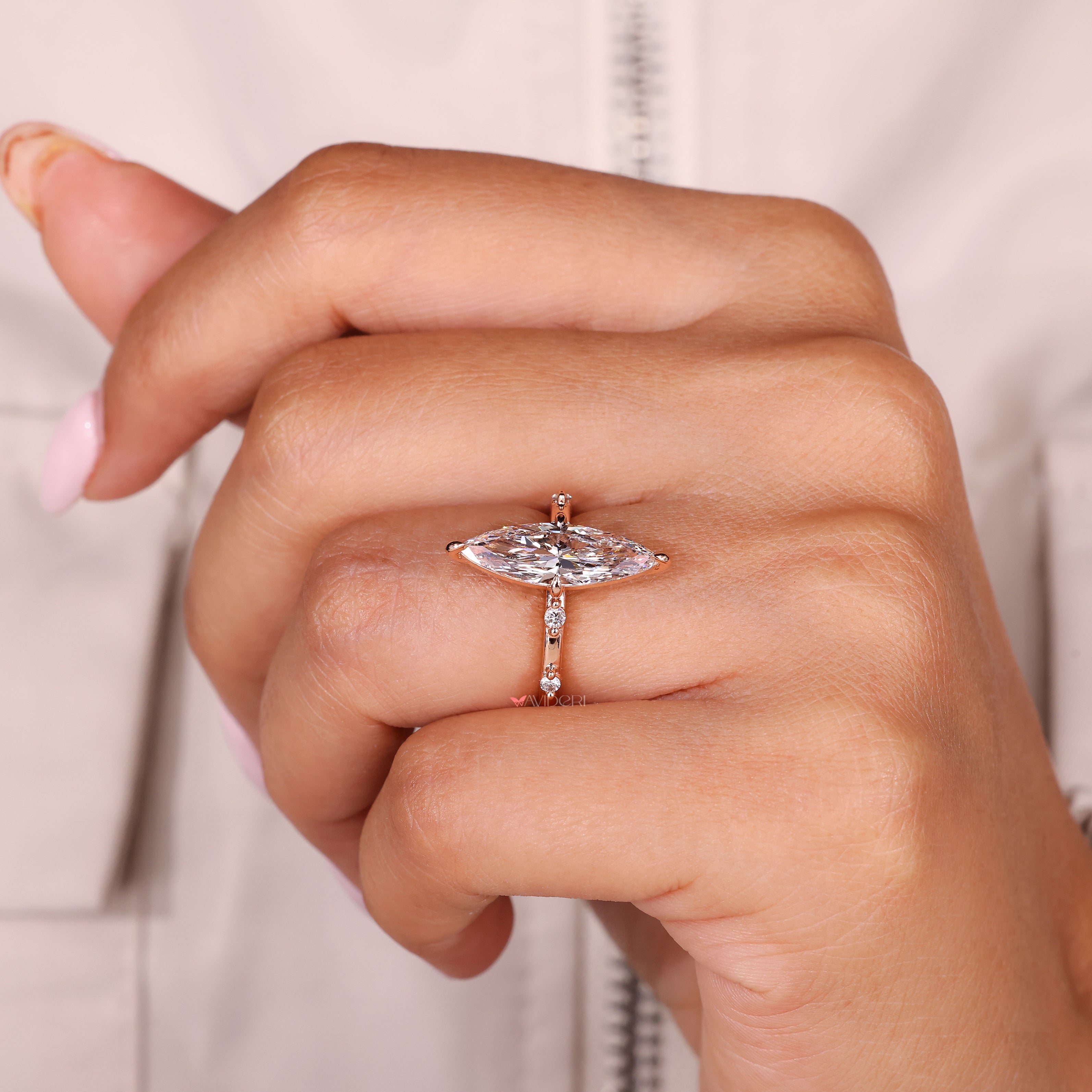 Handmade marquise engagement ring with round pave diamond details
