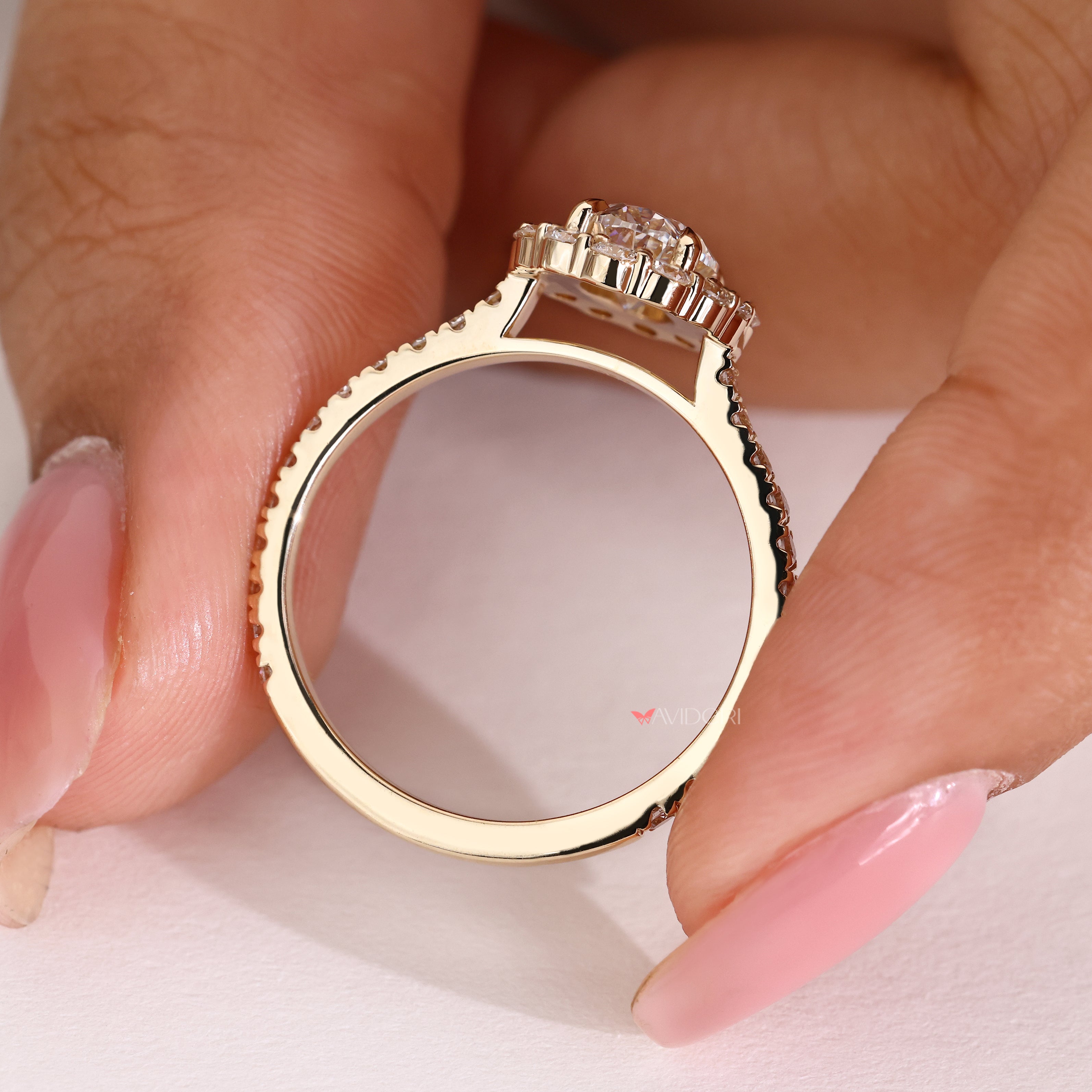 Oval diamond ring with four claw prong setting style
