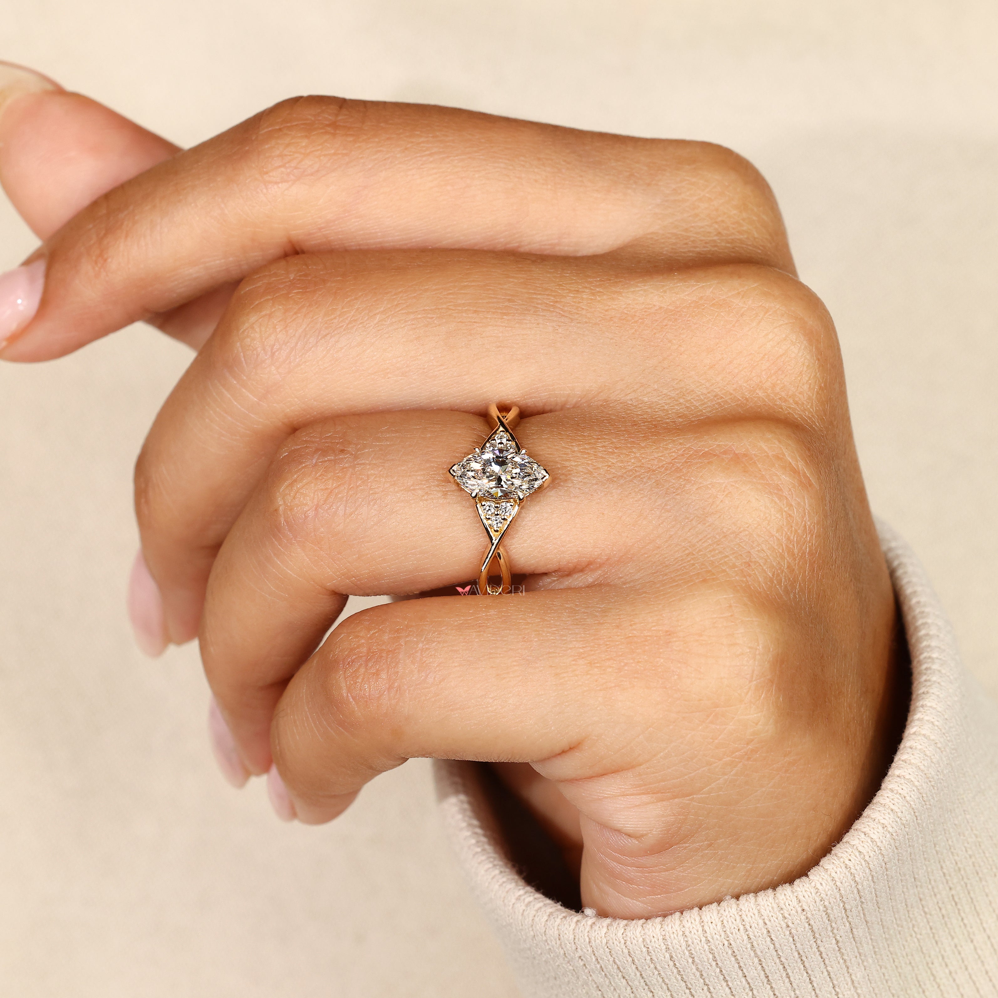Lab grown marquise ring with round side stones.

