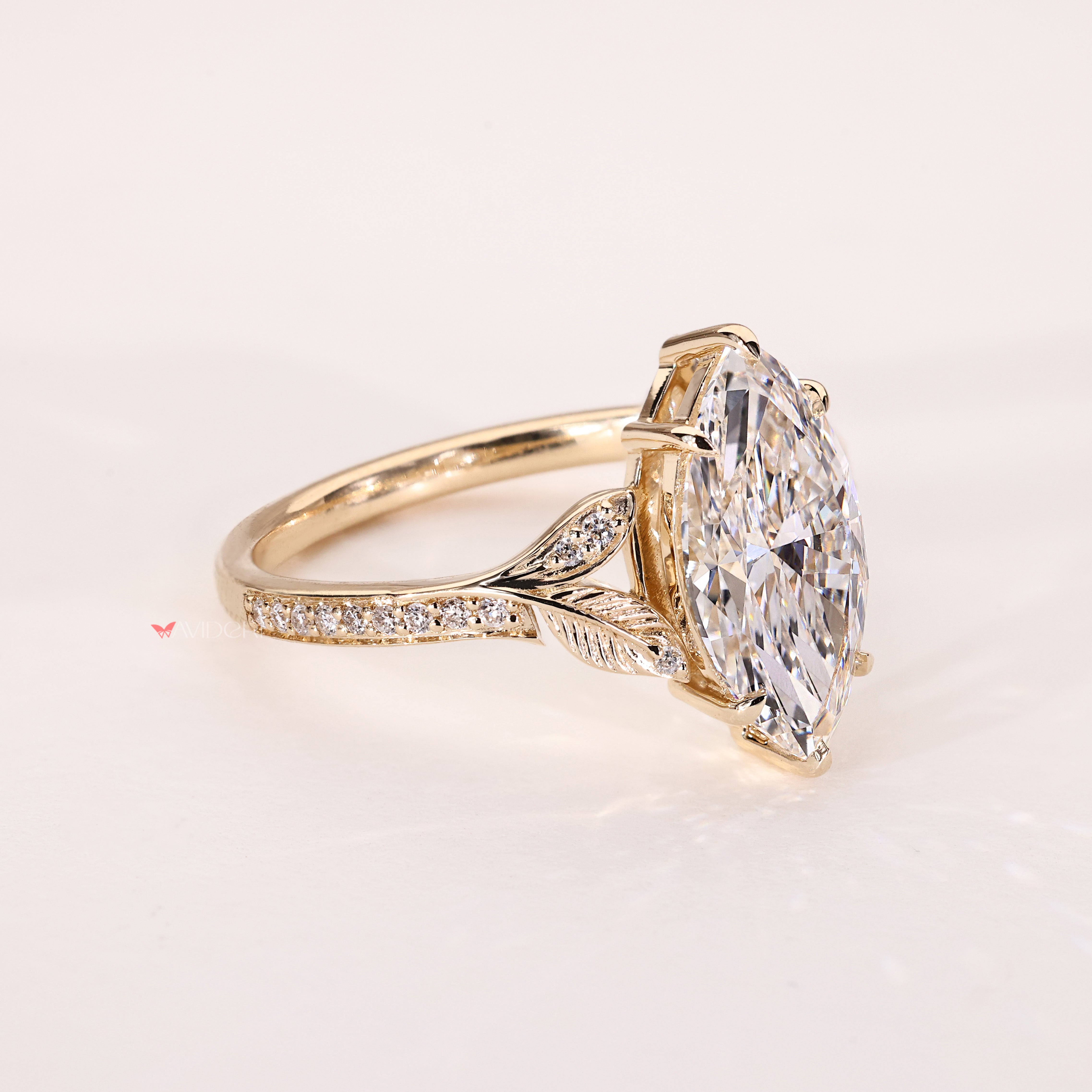 Vintage style marquise diamond ring with round side stones
