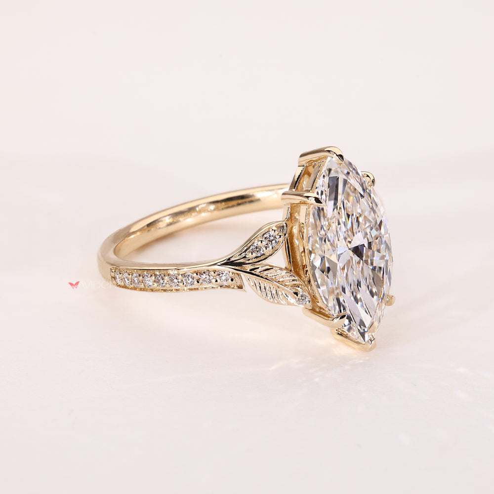 Vintage style marquise diamond ring with round side stones
