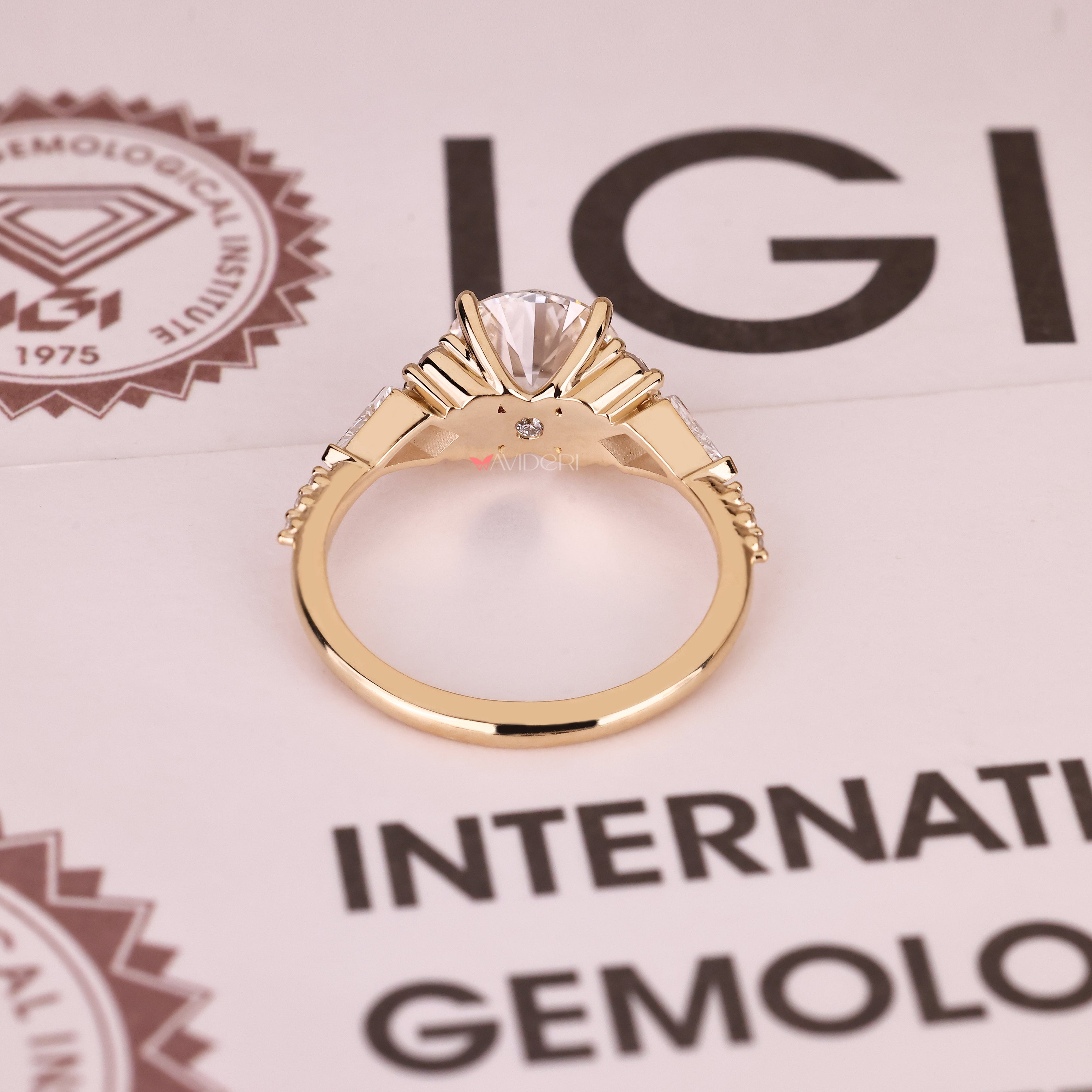 IGI certified round ring with kite side stone design
