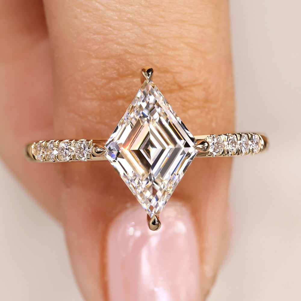 Lozenge cut diamond ring pave style with stones.
