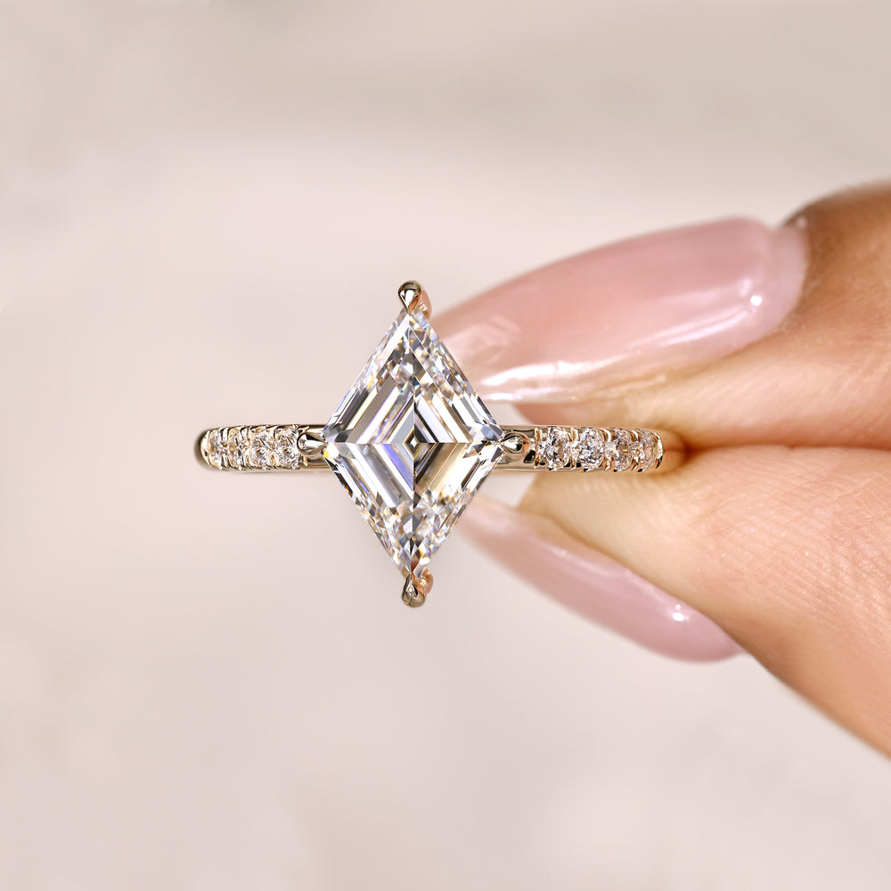Lozenge diamond ring with round pave setting.

