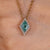 Lozenge cut pendant with cyan blue moissanite.
