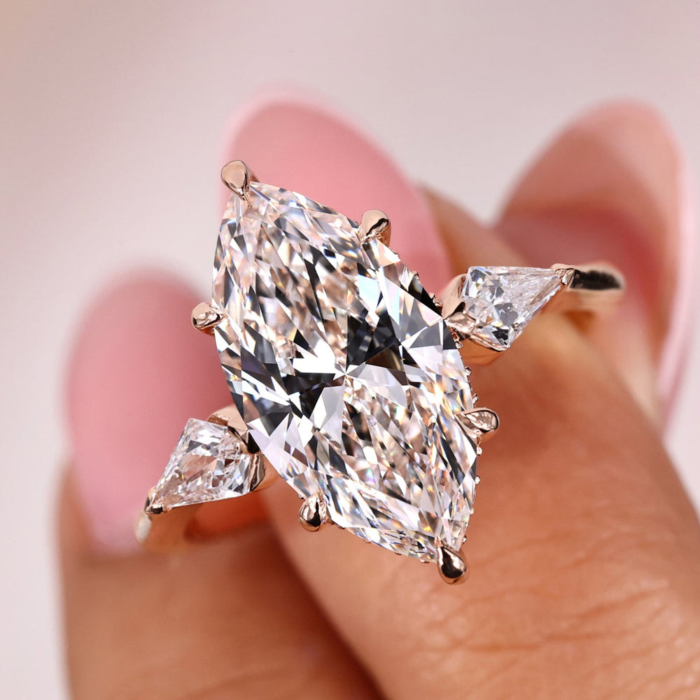 Marquise diamond ring featuring a stunning three stone setting
