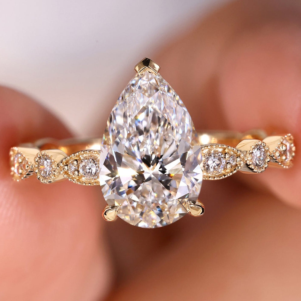 Pear shaped diamond ring with an elegant design for timeless beauty.
