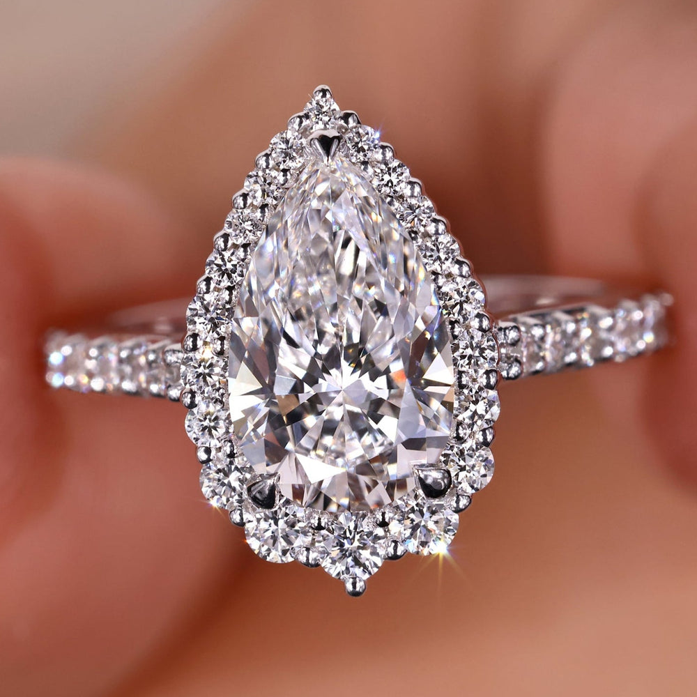 Halo diamond engagement ring featuring a stunning pear shaped diamond ring design.
