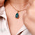 Pear shaped pendant with three claw prong setting.