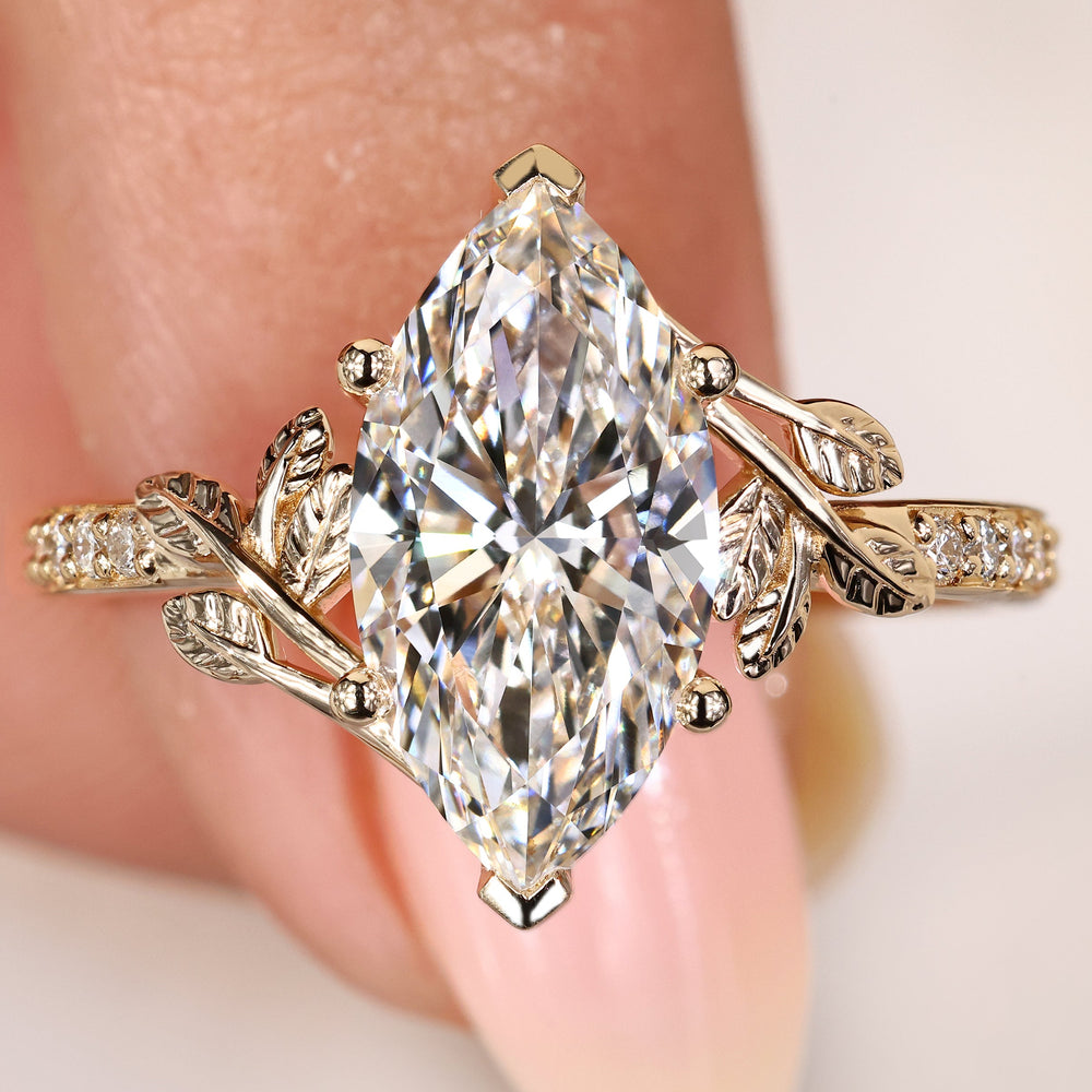 Marquise cut diamond ring with pave and leaf details
