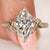 Marquise cut diamond ring with pave and leaf details
