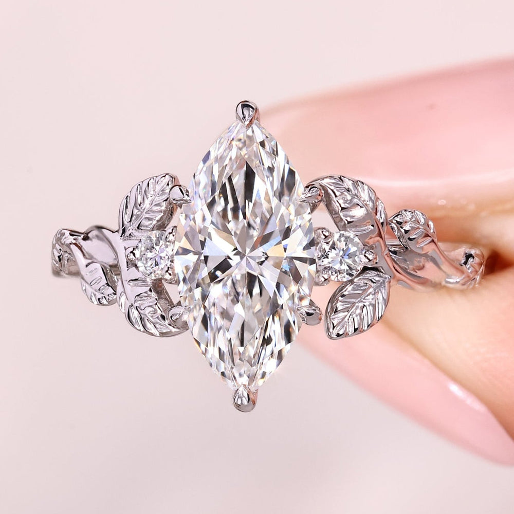 Six prong marquise diamond three stone ring.
