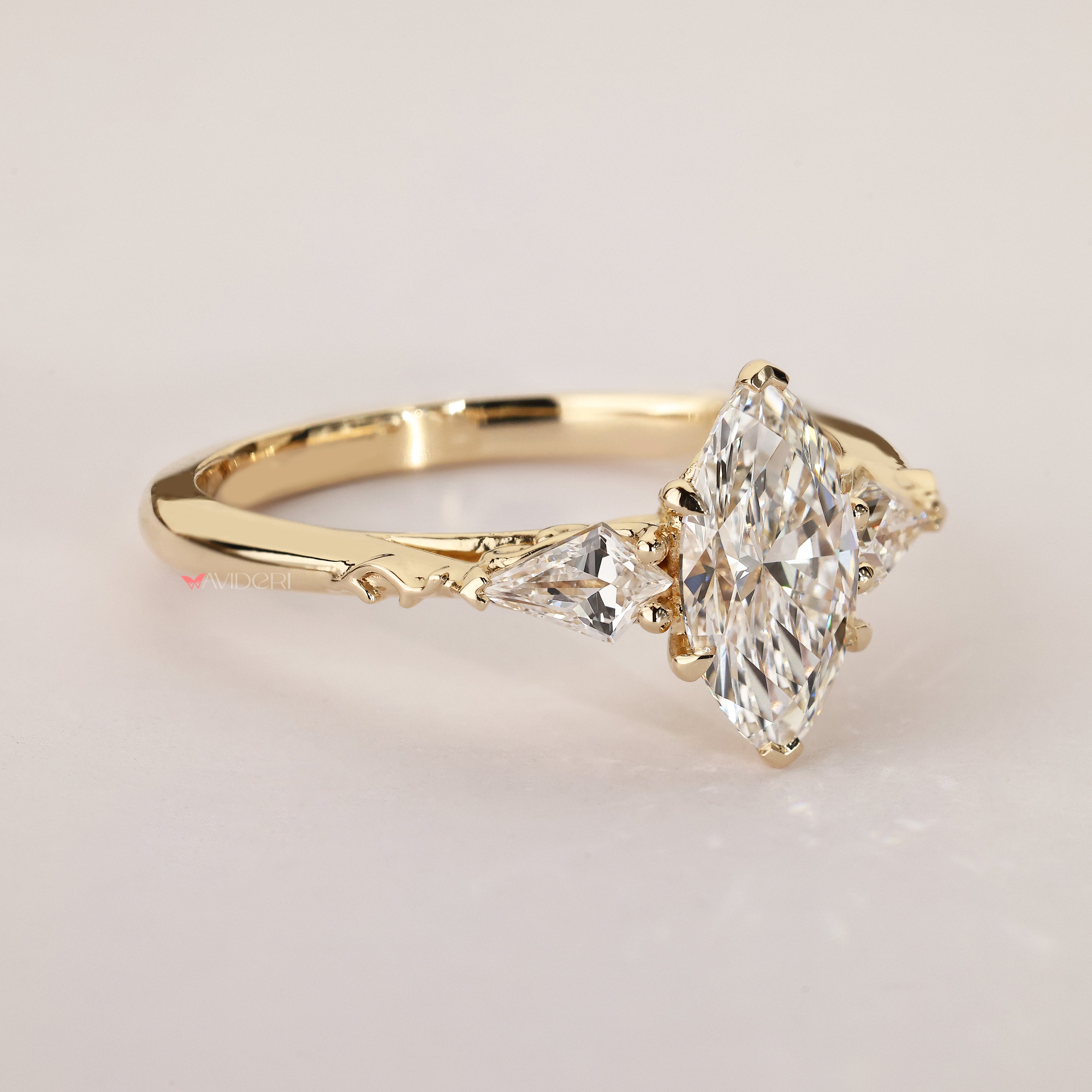 Three stone ring with marquise and kite diamonds.

