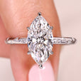 Marquise cut diamond ring with flush pave band.
