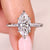 Marquise cut diamond ring with flush pave band.
