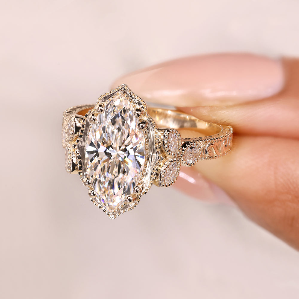Marquise cut ring with cathedral setting and side stones
