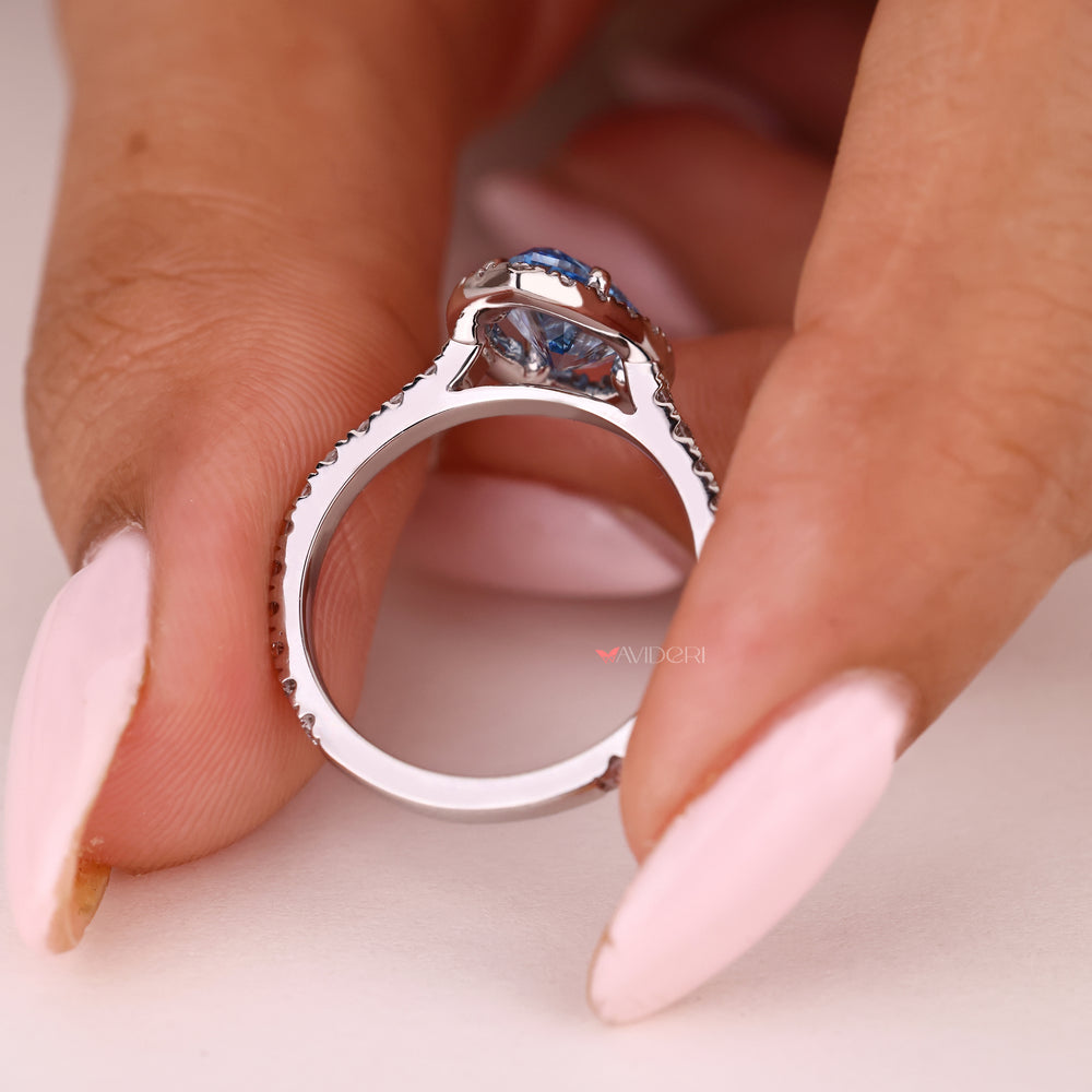 Handmade blue diamond ring with pave and halo setting
