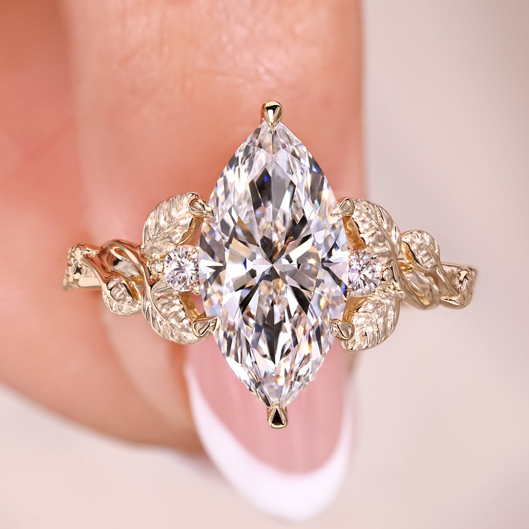 Marquise Cut diamond Ring with round cut side stones.