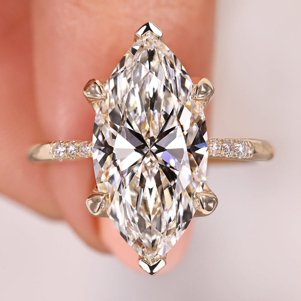Marquise diamond engagement ring featuring a tapered shank.