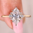 Marquise diamond engagement ring with round side diamonds.
