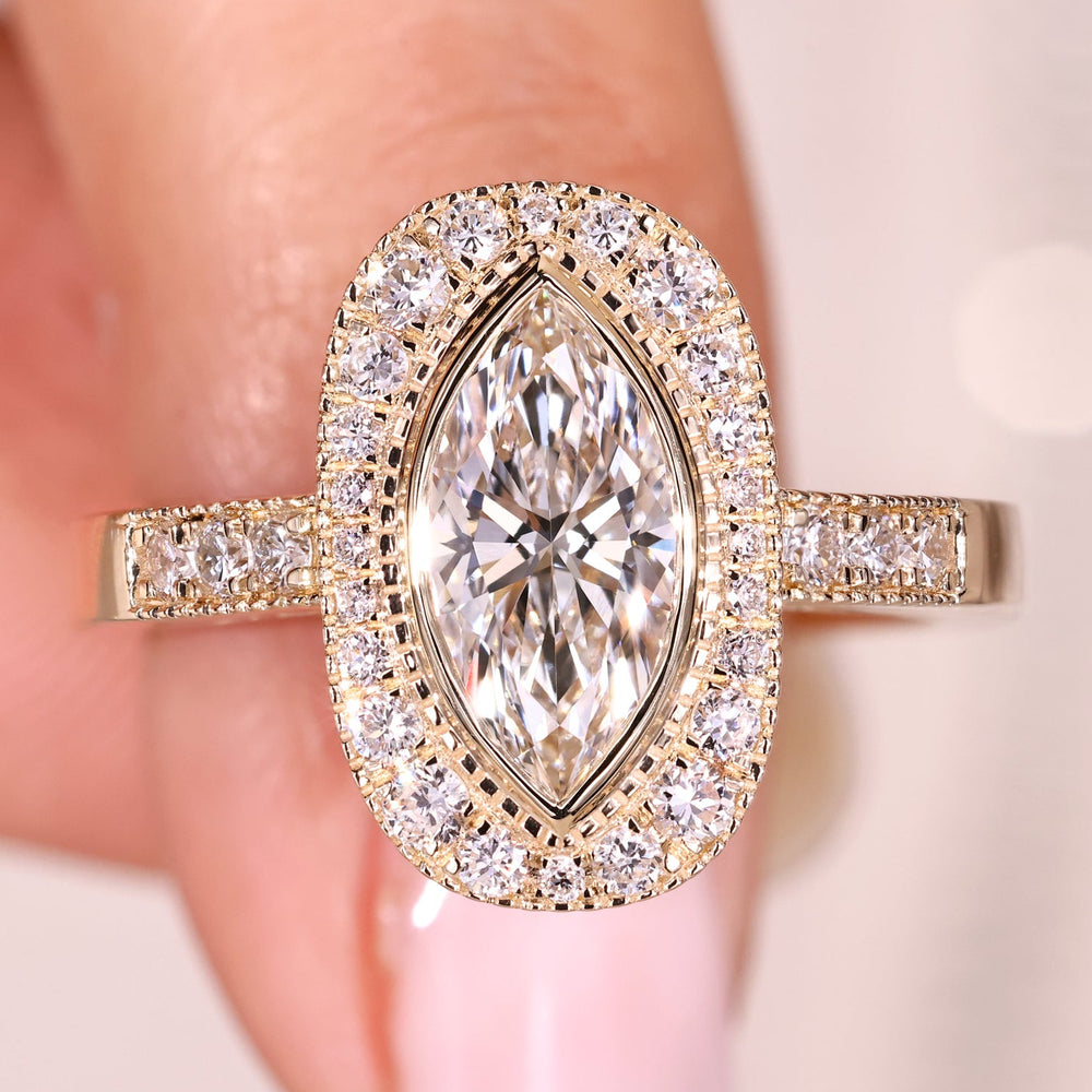Marquise diamond ring with halo and pave band.
