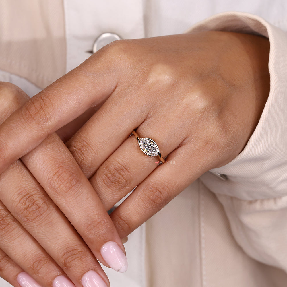 East west marquise ring with diamond solitaire.

