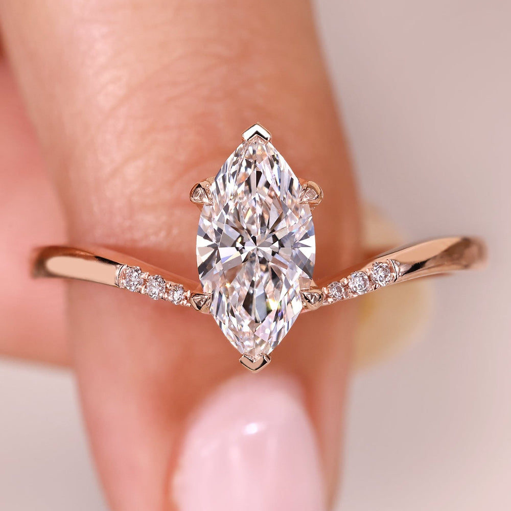 Marquise diamond ring with pave style band.

