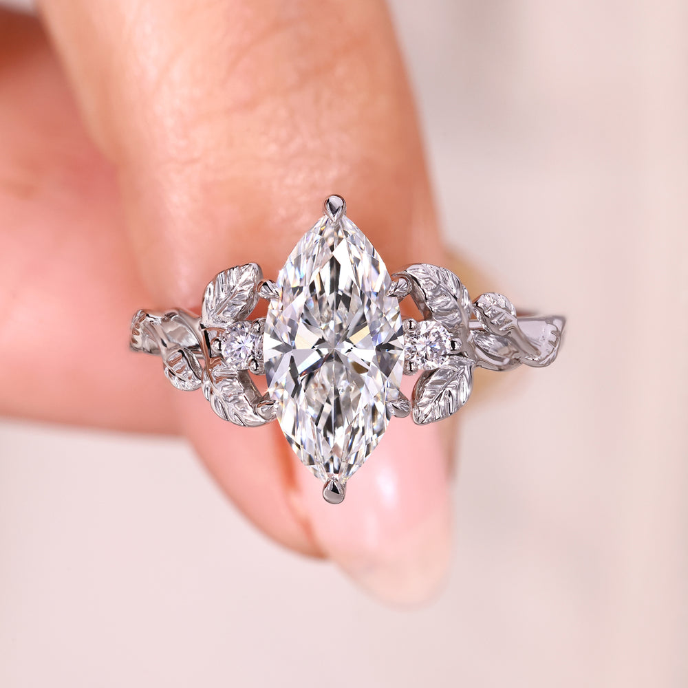 Marquise diamond ring with round side stones.