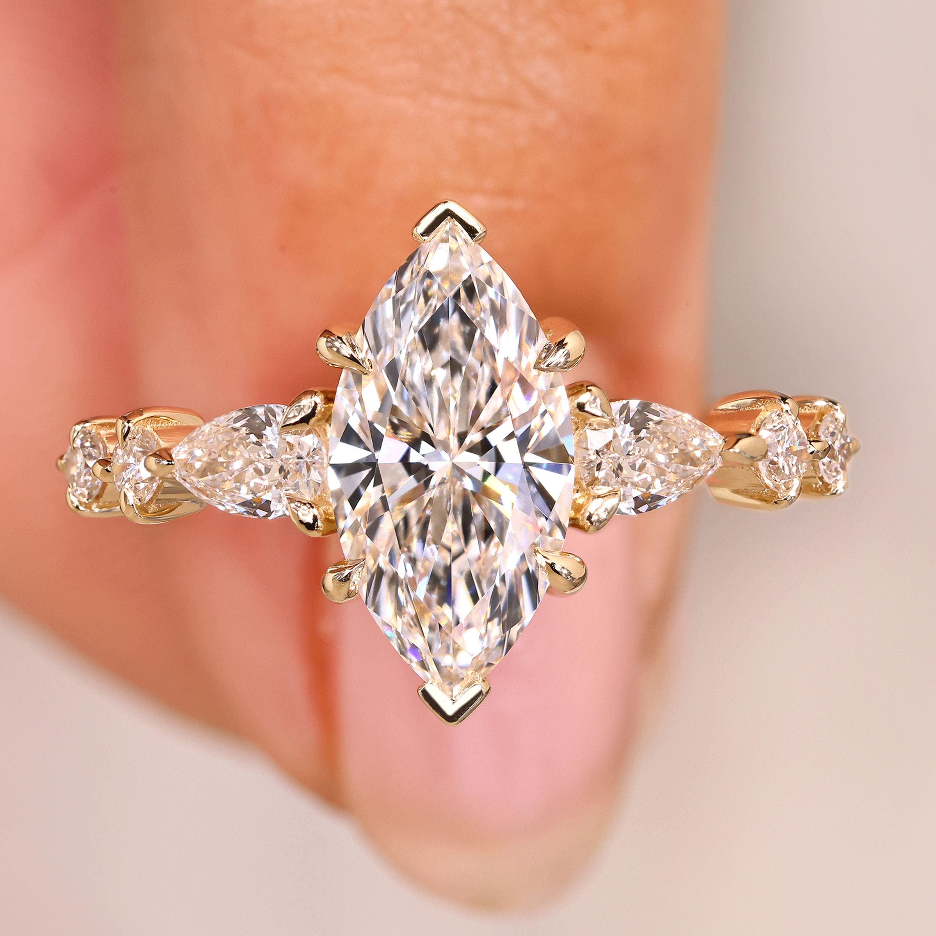 Marquise diamond ring with pear round pave style.
