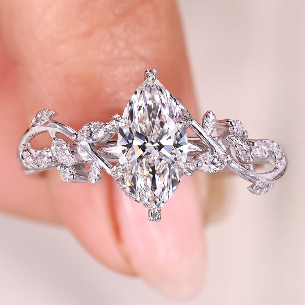 Marquise diamond ring with leaf inspired prong setting.
