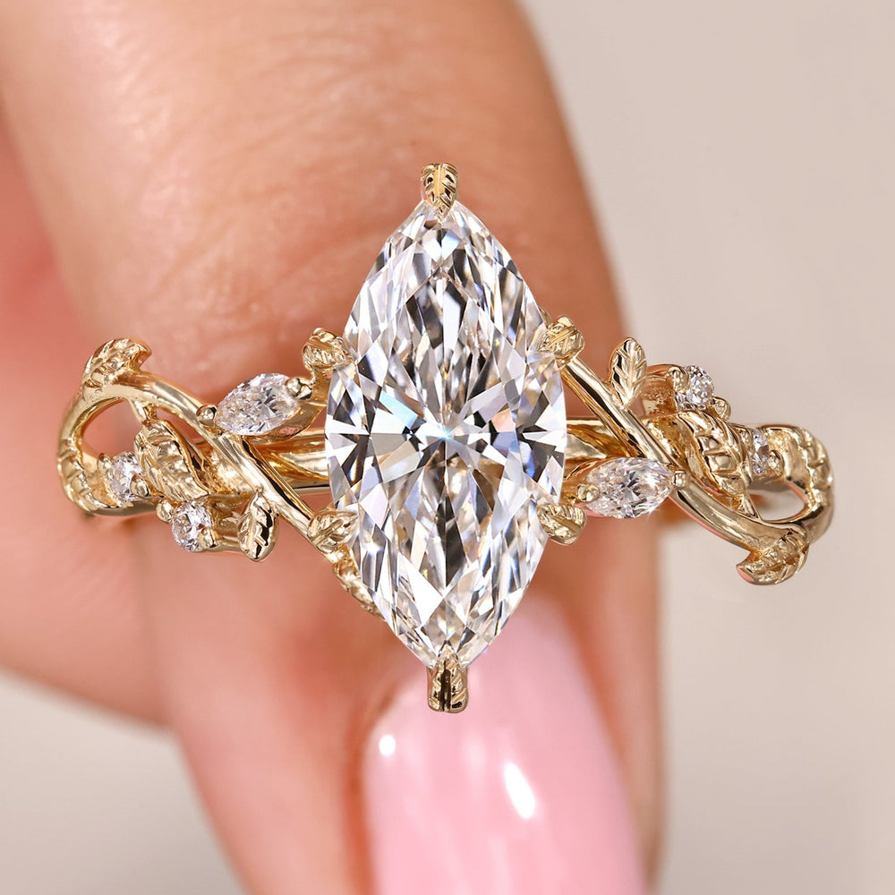 Marquise cut diamond ring with nature inspired filigree style.
