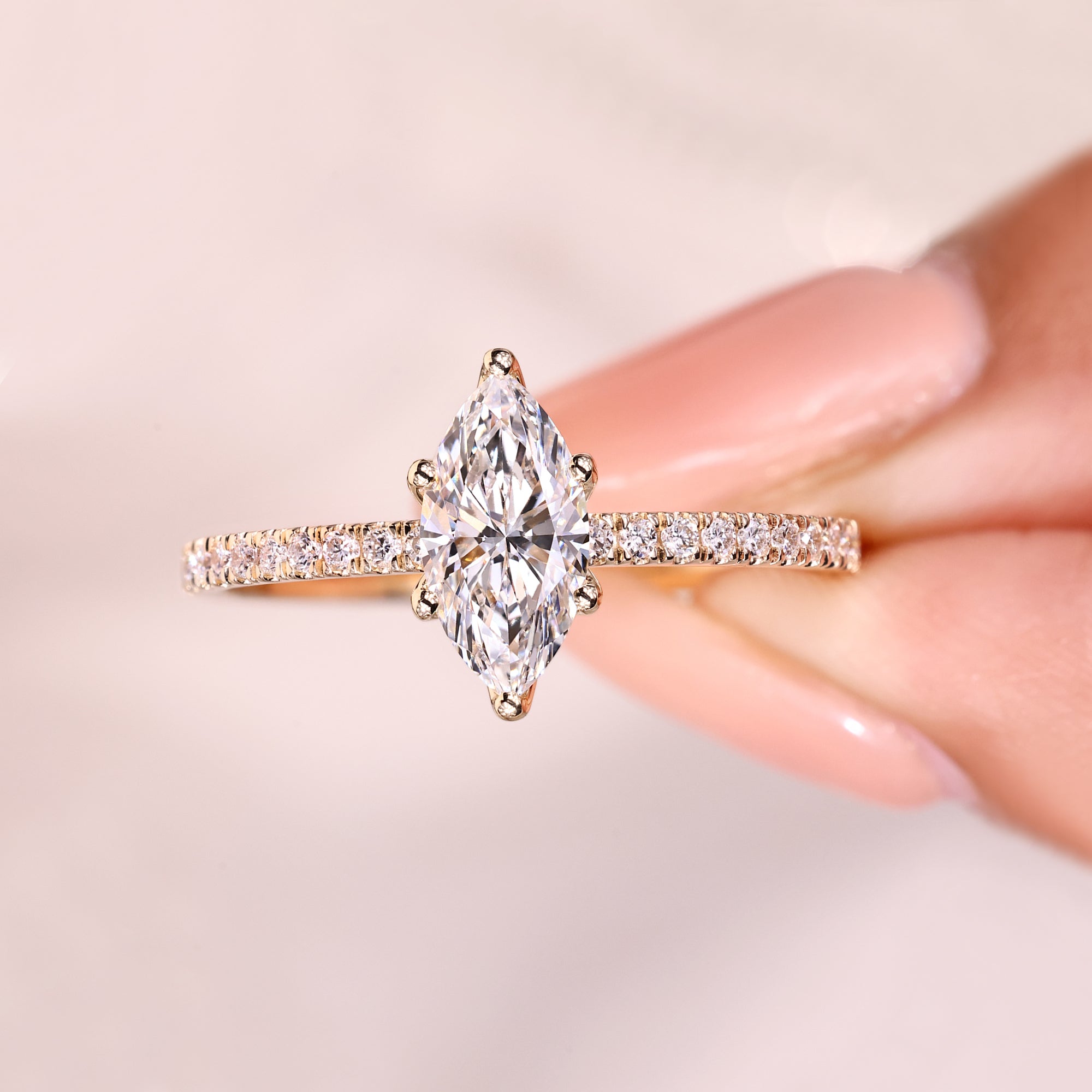 Marquise diamond ring with round diamond accents.
