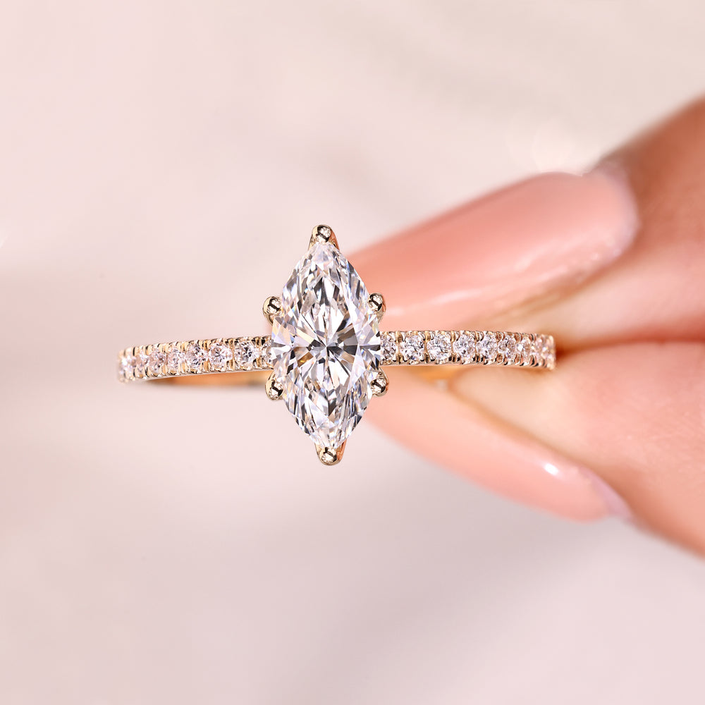 Marquise diamond ring with round diamond accents.
