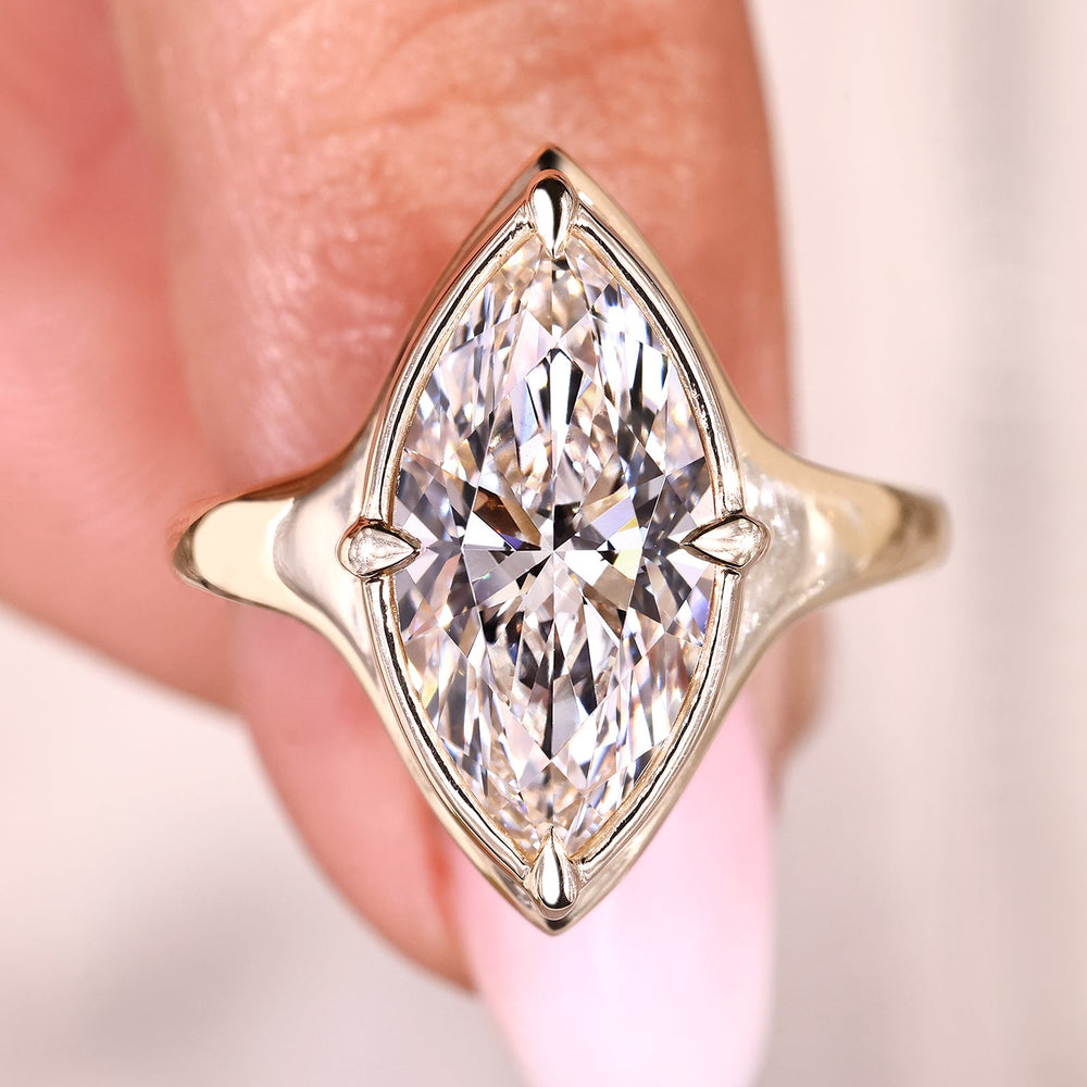 Marquise solitaire diamond ring with sleek profile.