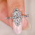 marquise diamond engagement ring with round diamond accents in white gold.