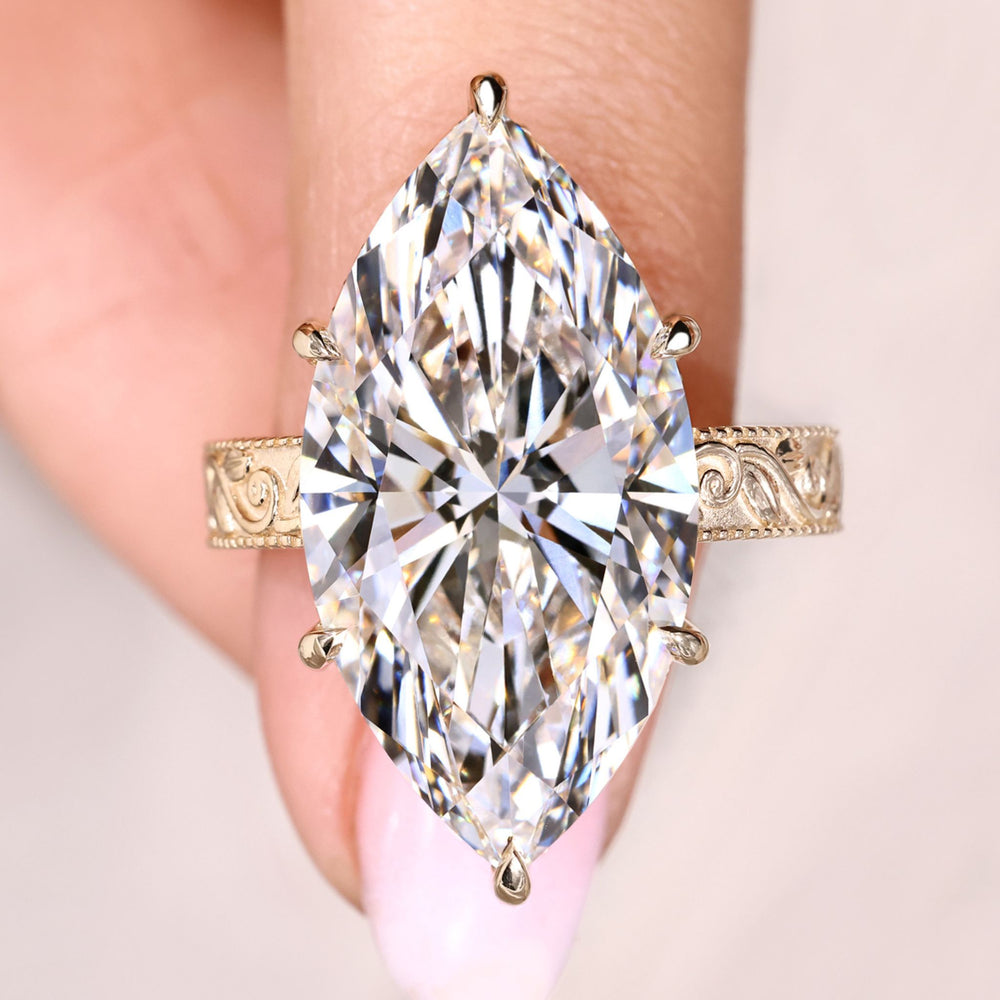 Hidden halo marquise diamond ring in yellow gold.