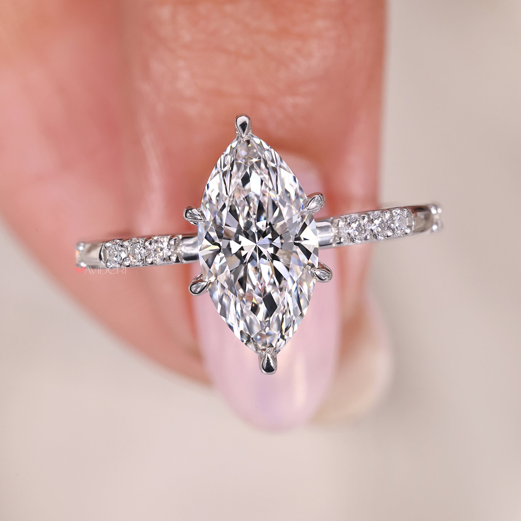 marquise diamond engagement ring with lab grown diamond and handmade setting.