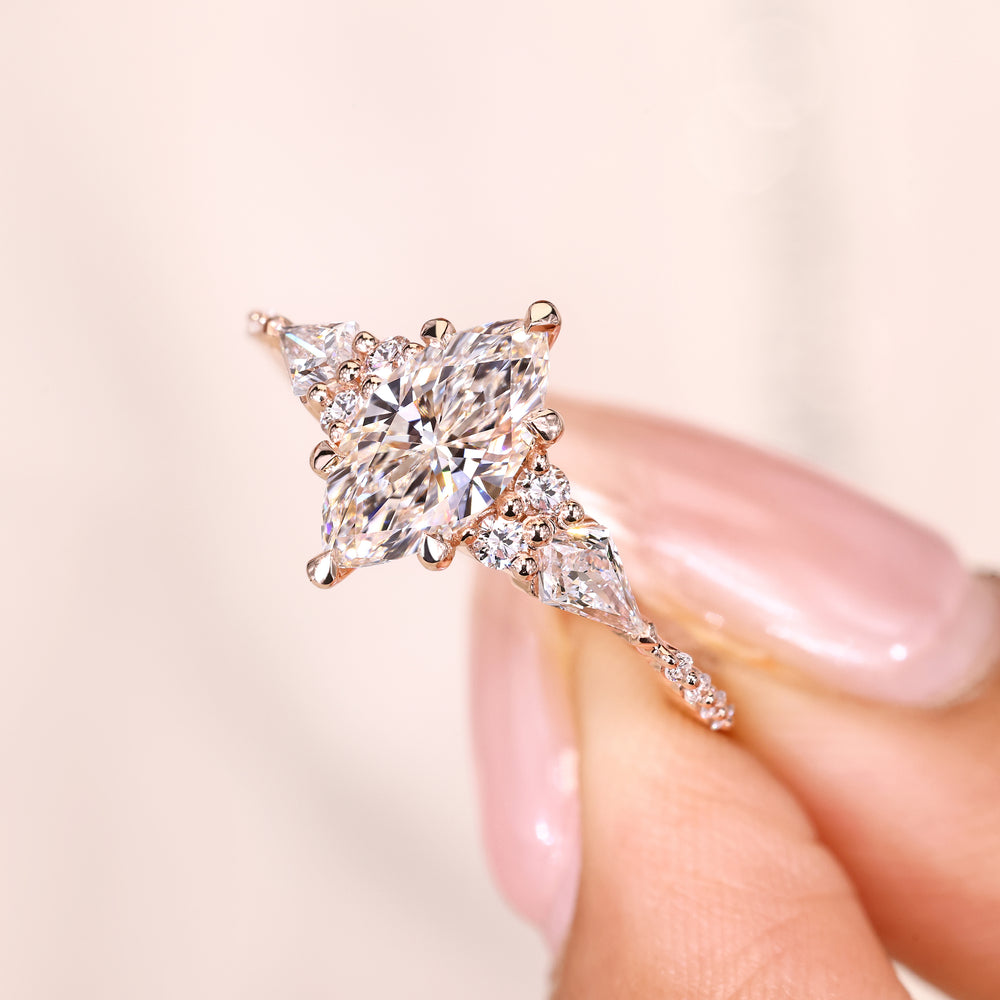 Marquise ring with kite and round stone accents.
