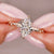 marquise diamond engagement ring with round diamonds in custom yellow gold setting.
