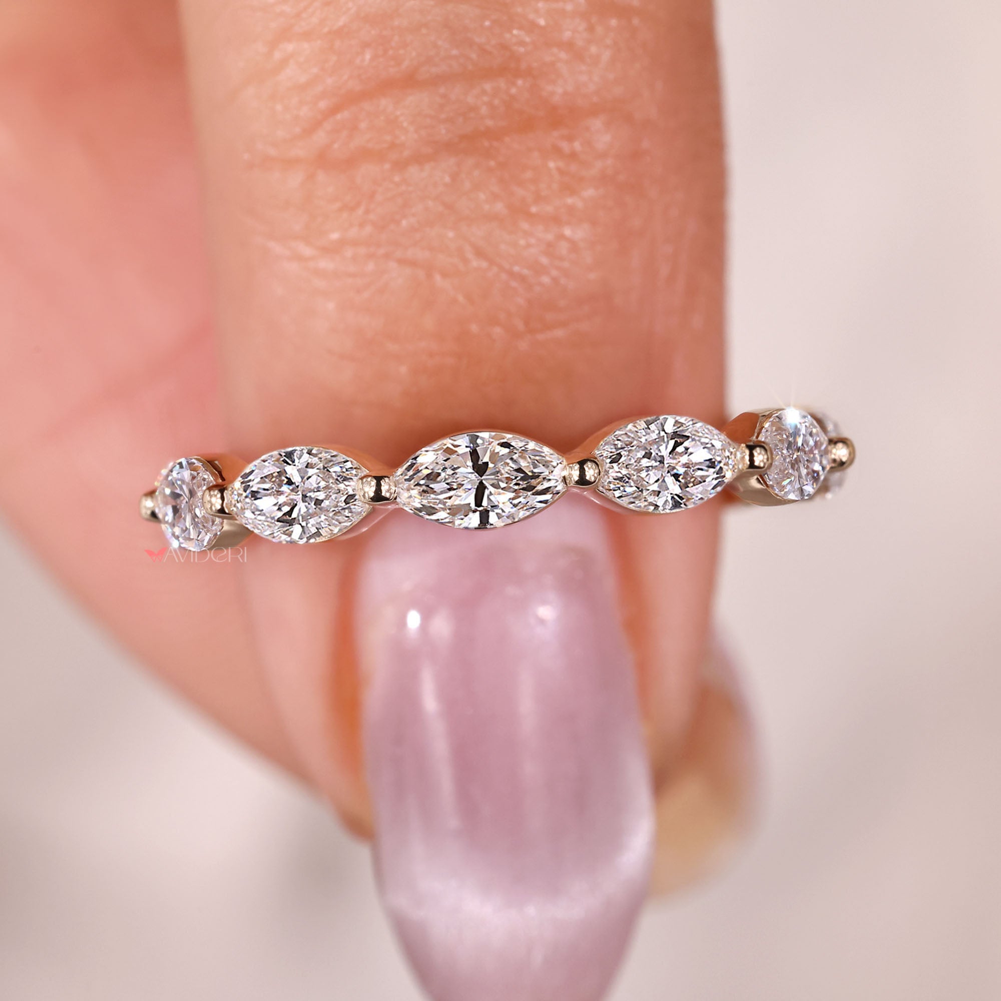 Shared prong marquise diamond wedding band.