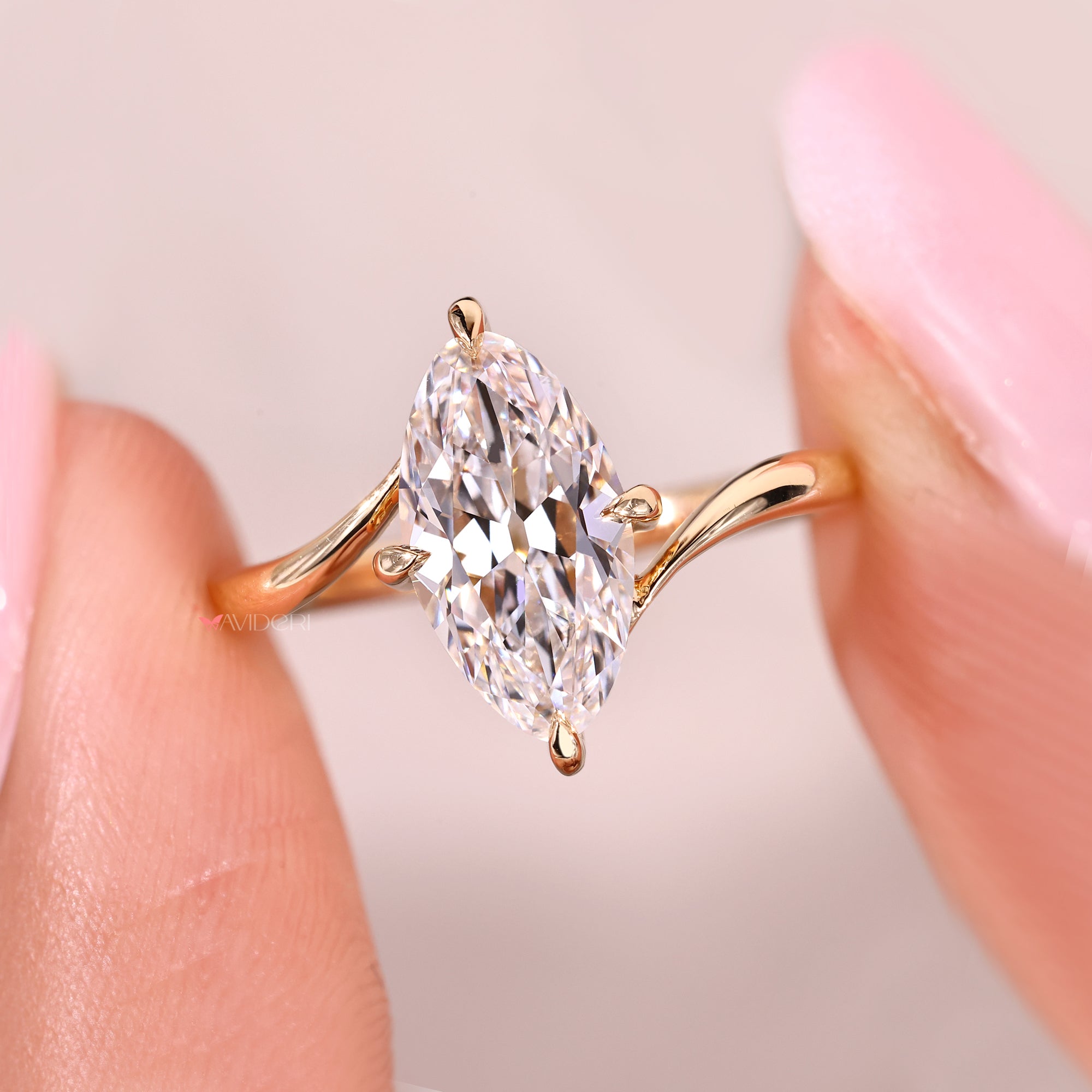 Solitaire ring with marquise diamond and bypass design.