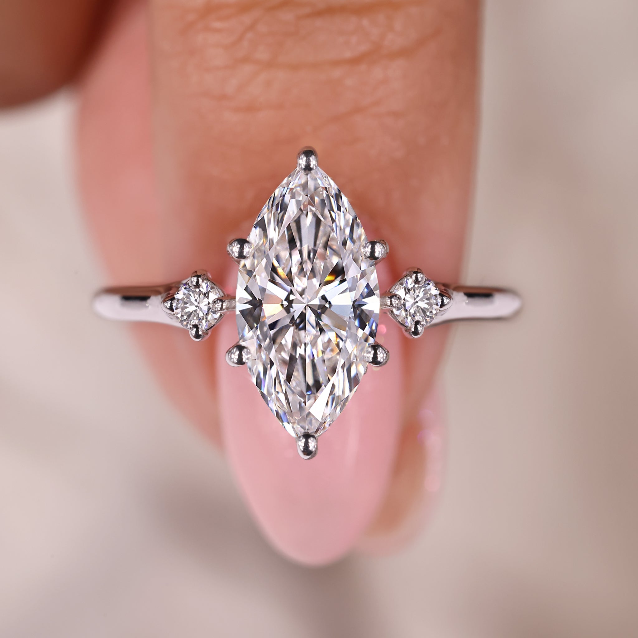 Marquise diamond ring with round cut hidden halo setting.