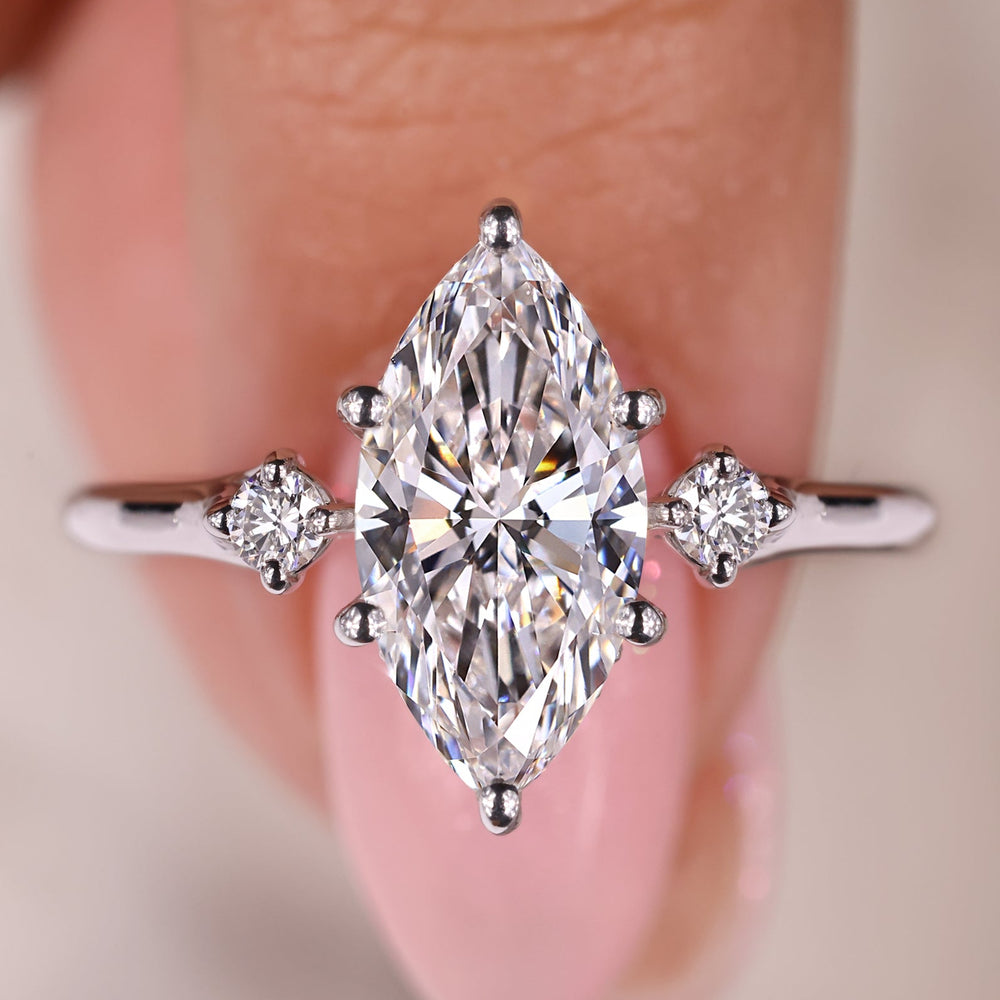 Marquise diamond ring with round cut hidden halo setting.