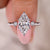 Marquise diamond ring with round cut hidden halo setting.
