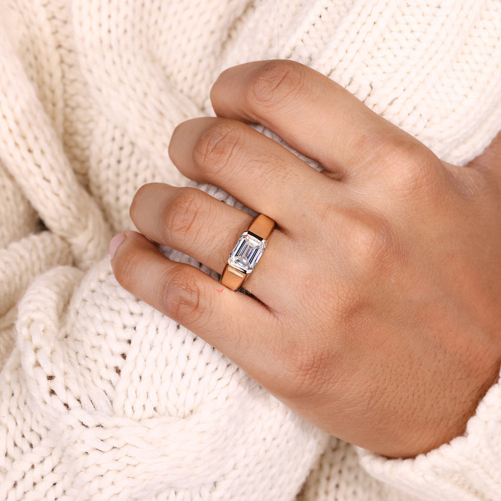 Solitaire style emerald moissanite ring design.
