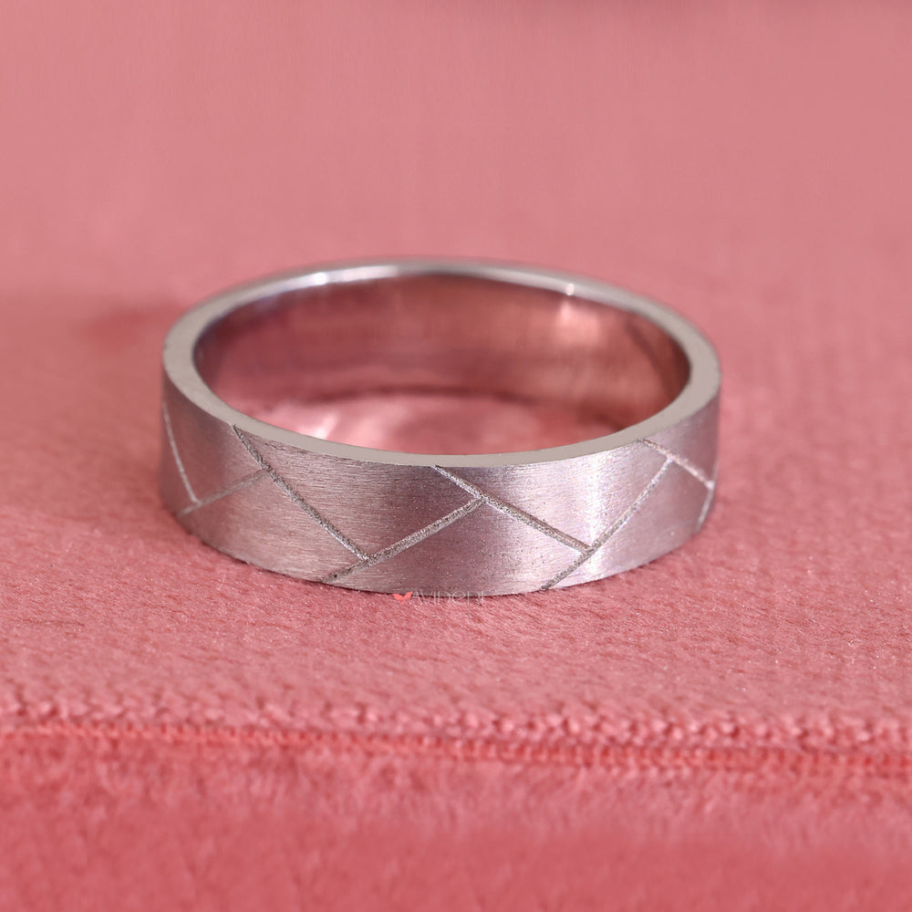 Simple mens wedding band keeps focus on clean, minimal form.

