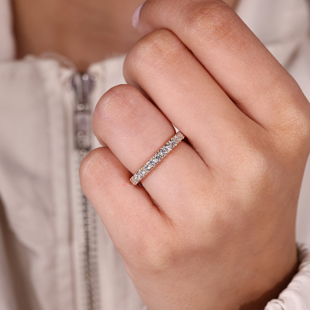 Round diamond wedding band with prong setting.

